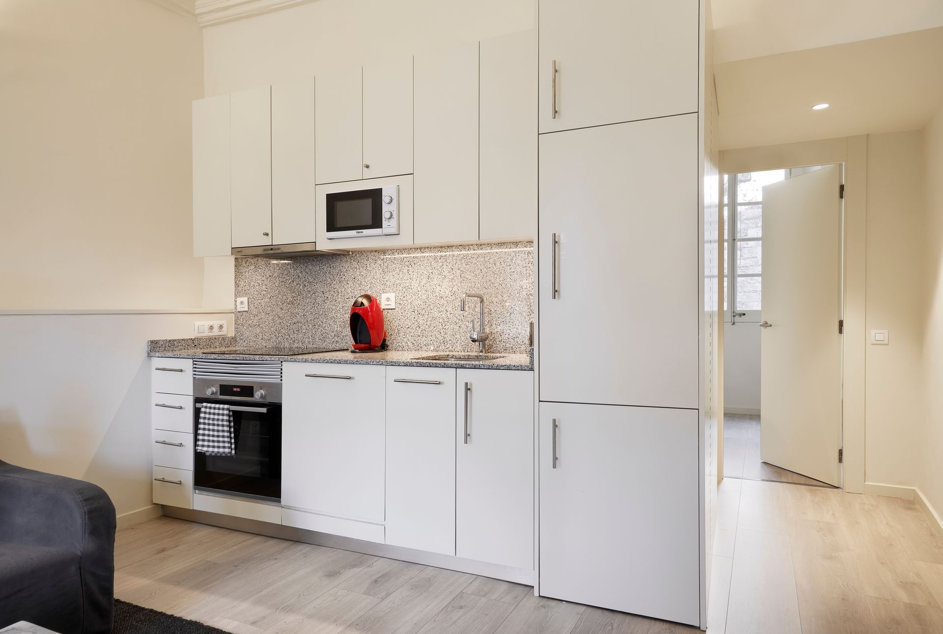 A kitchen with white cabinets and stainless steel appliances