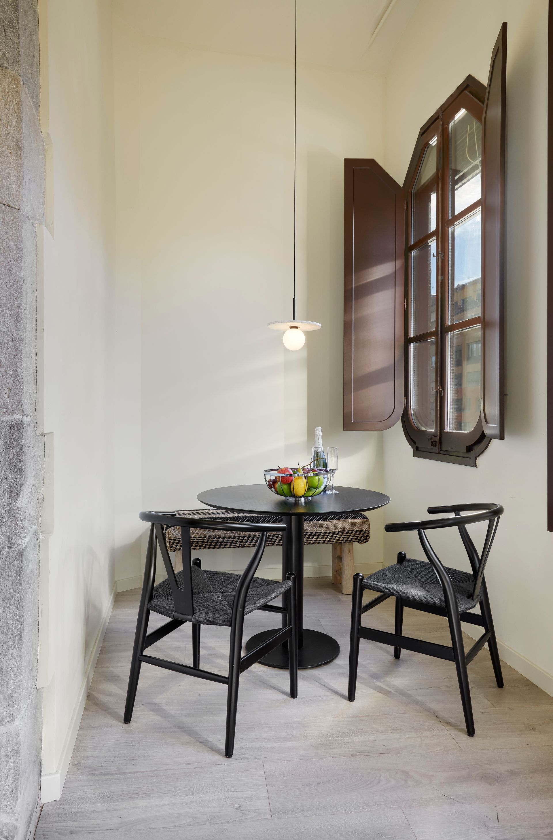 There is a table and chairs in the corner of the room.