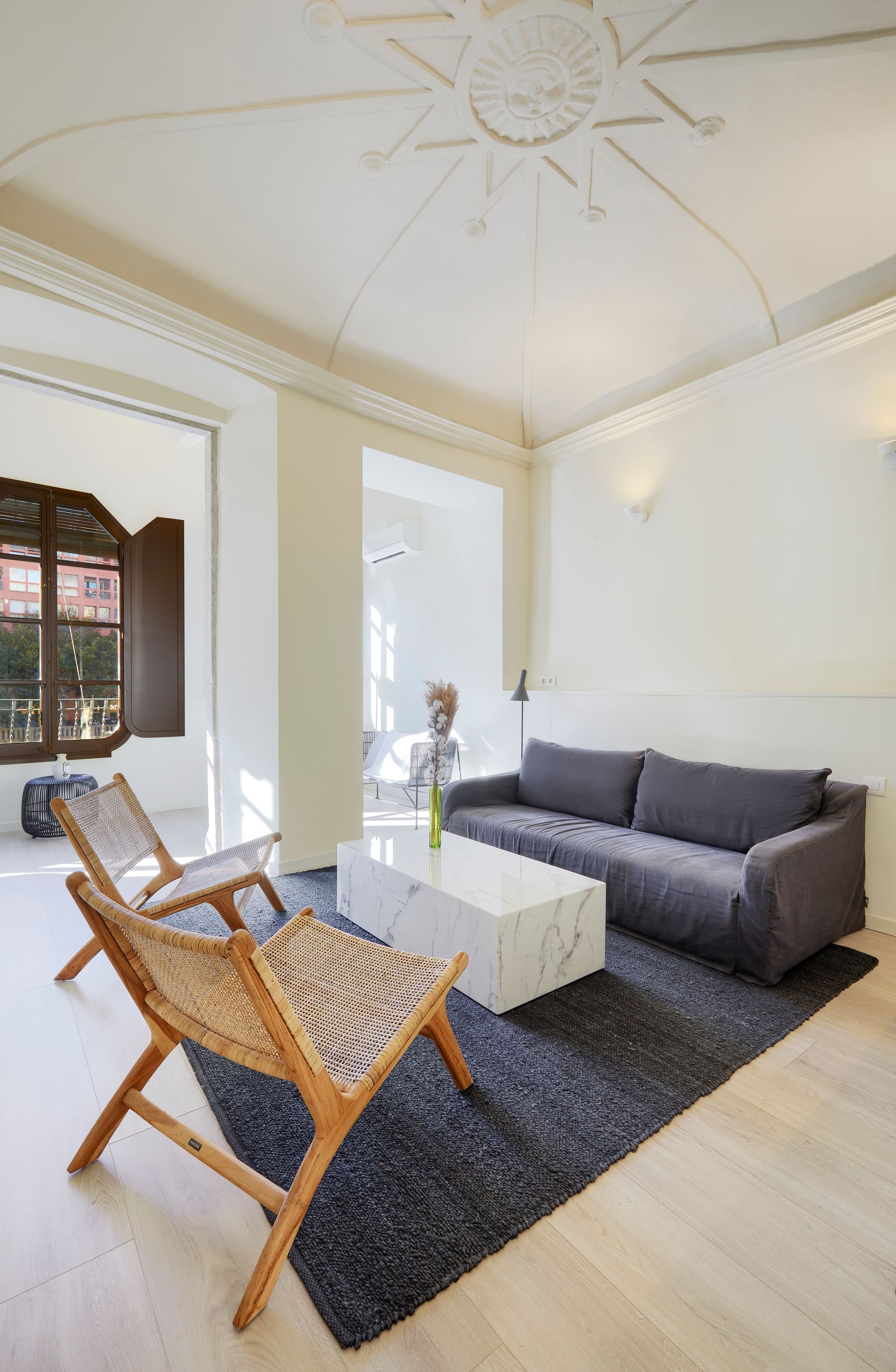 A living room with a couch , chairs , and a coffee table.