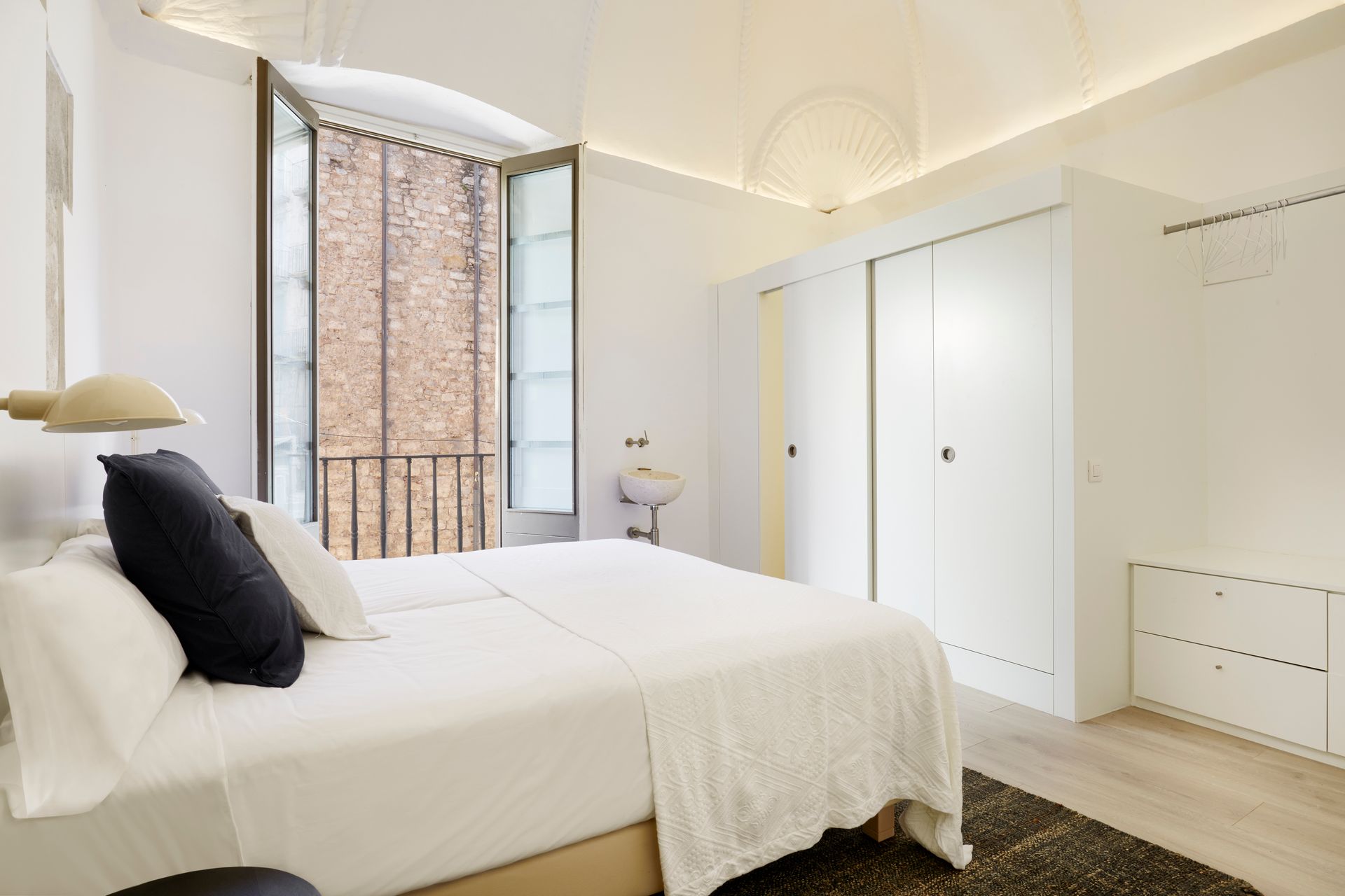 A bedroom with a large bed and a window.