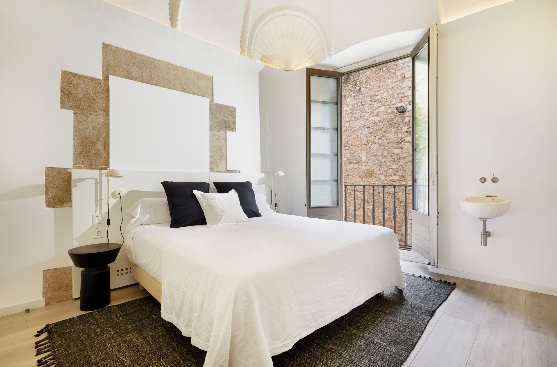 A bedroom with a bed and a sink in it