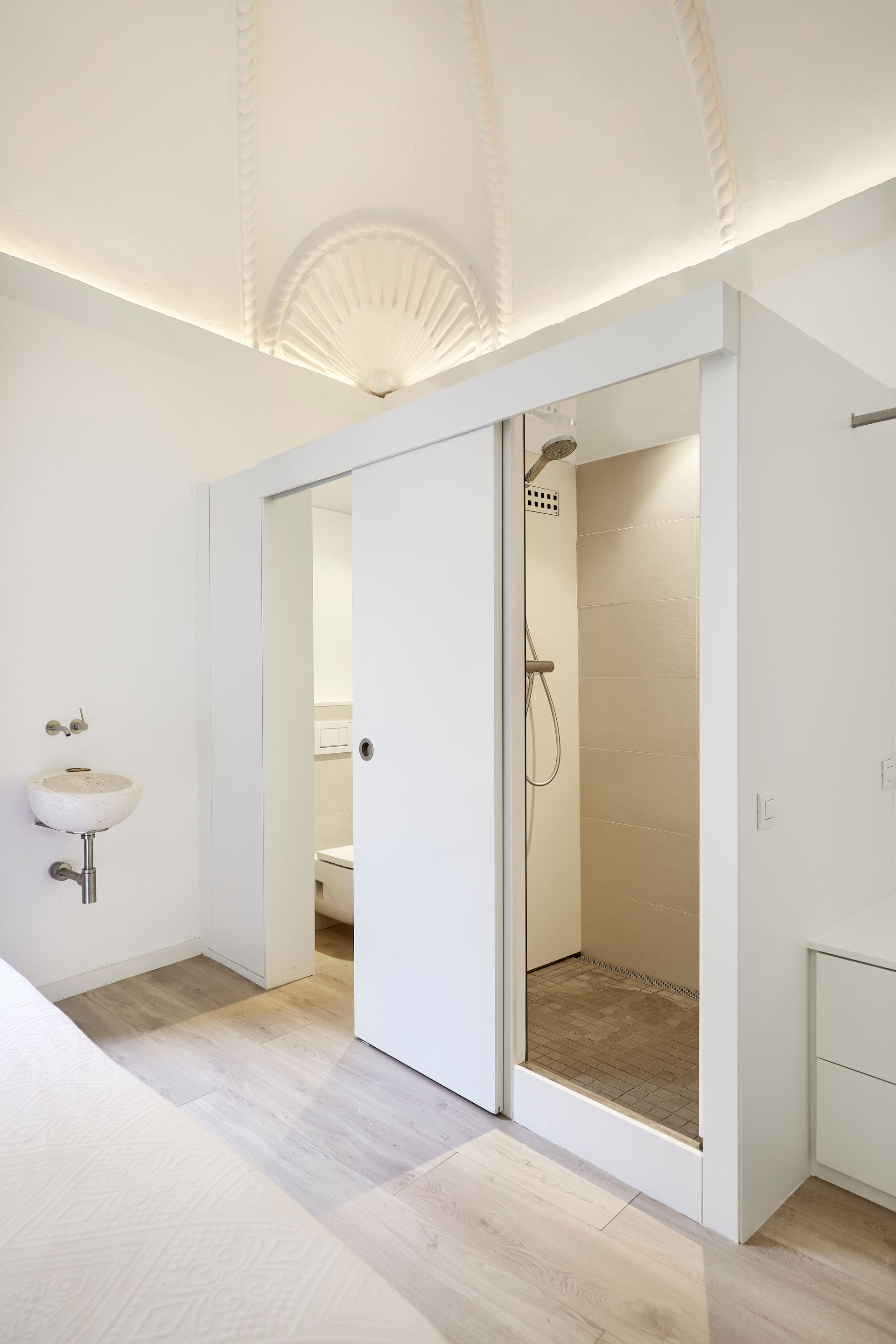 A bathroom with a sink , toilet and shower.