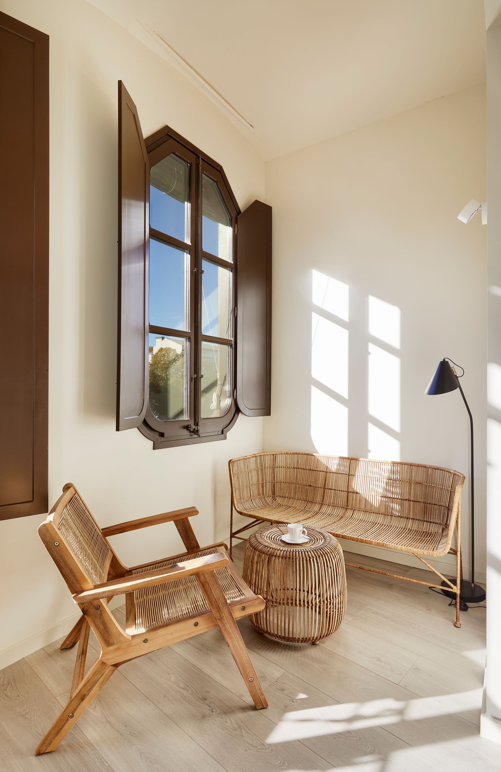 A living room with a couch , chair , table and window.