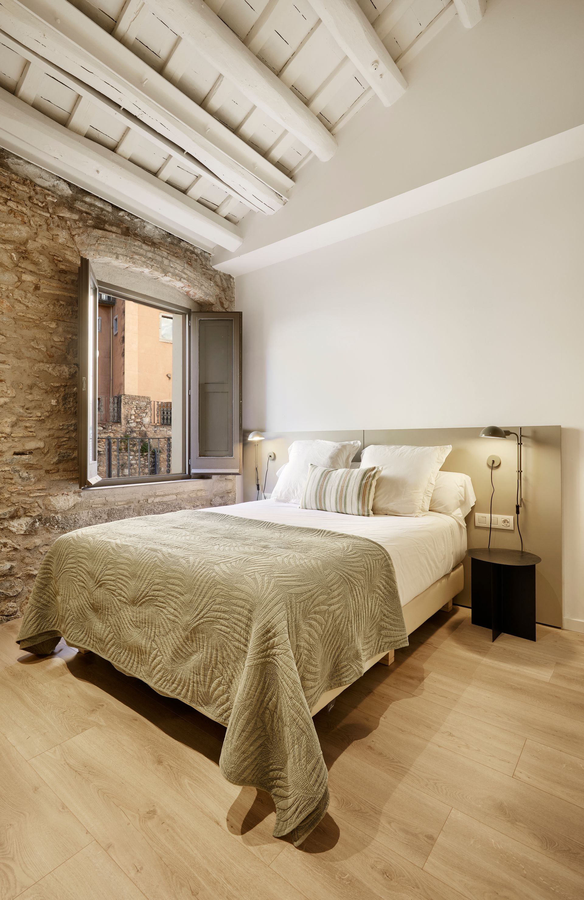 A bedroom with a large bed and a window.