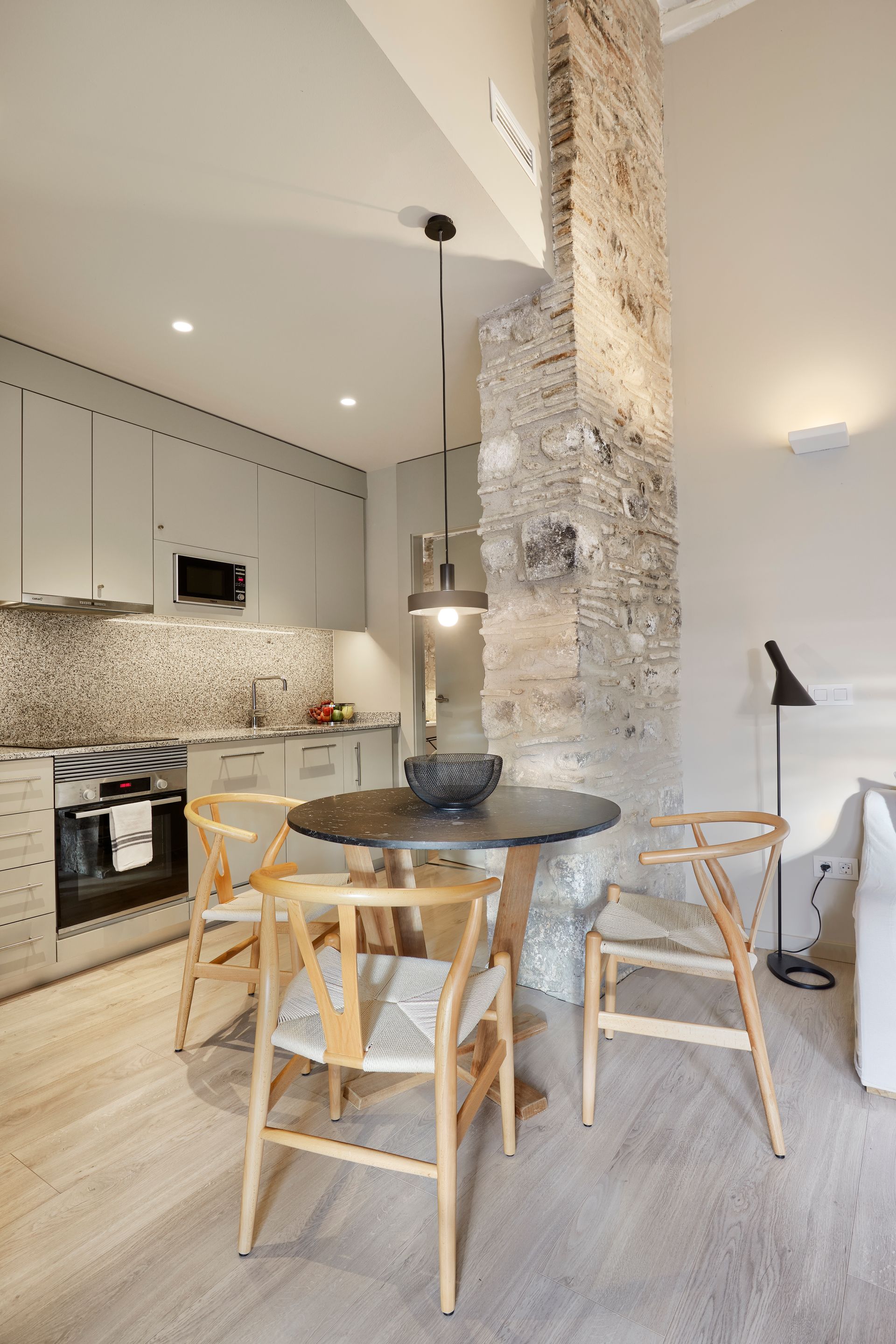 A kitchen with a table and chairs in it