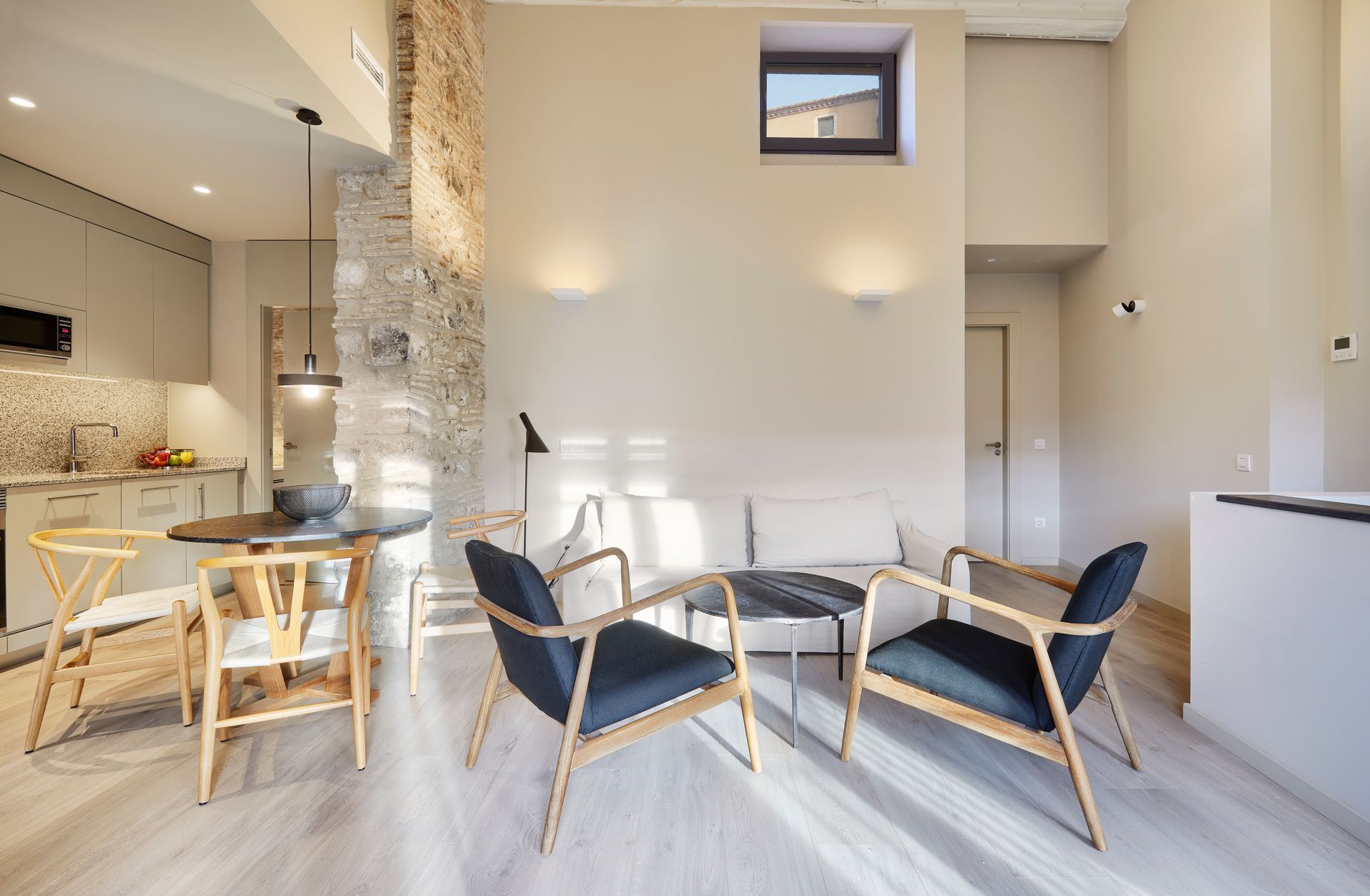 A living room with a table and chairs in it