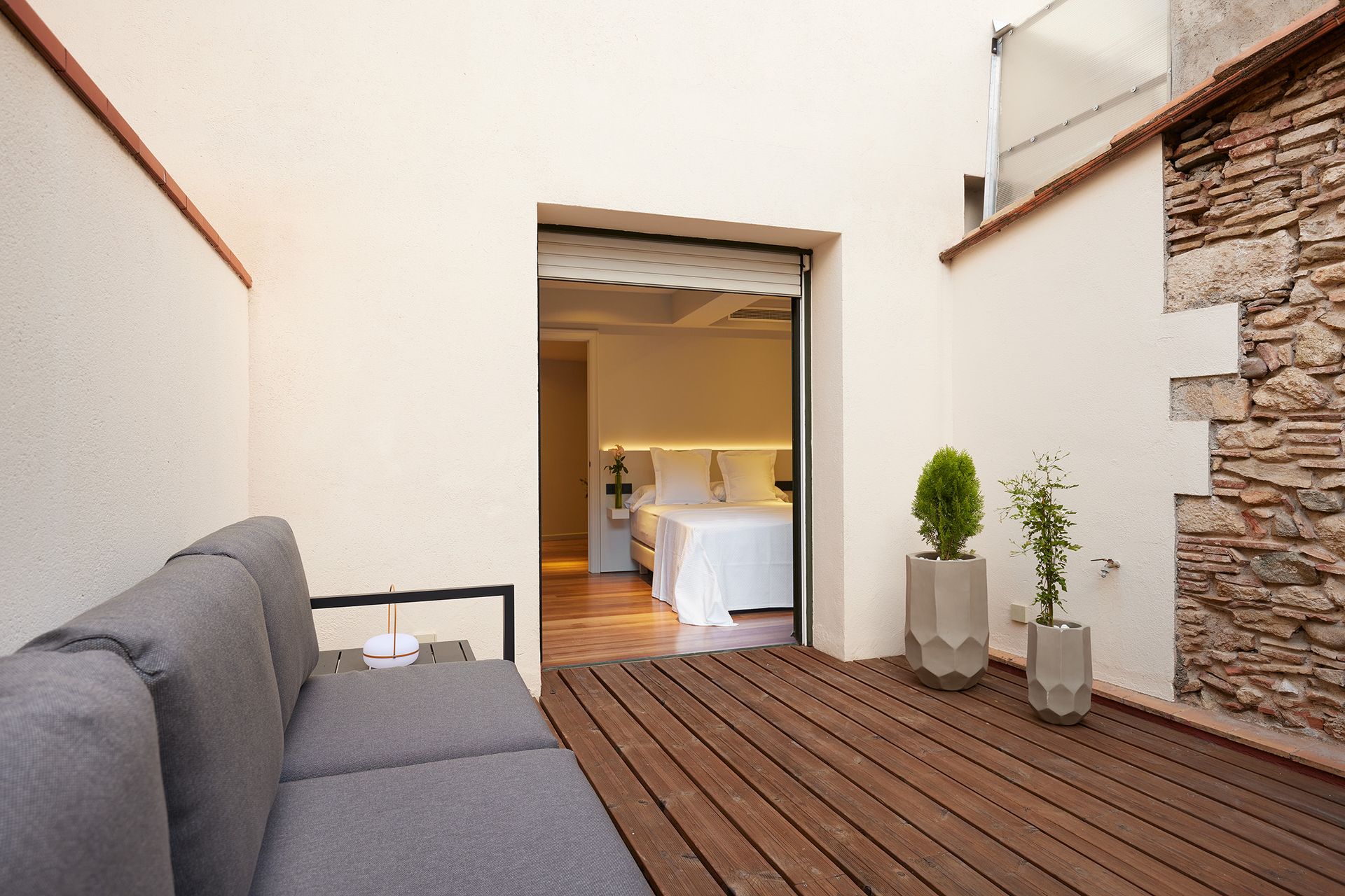 A balcony with a couch and potted plants