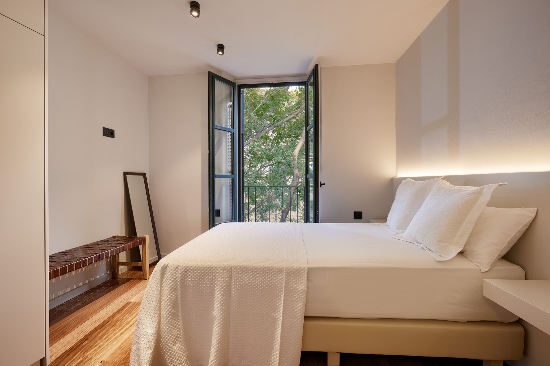 A bedroom with a large bed and a window.