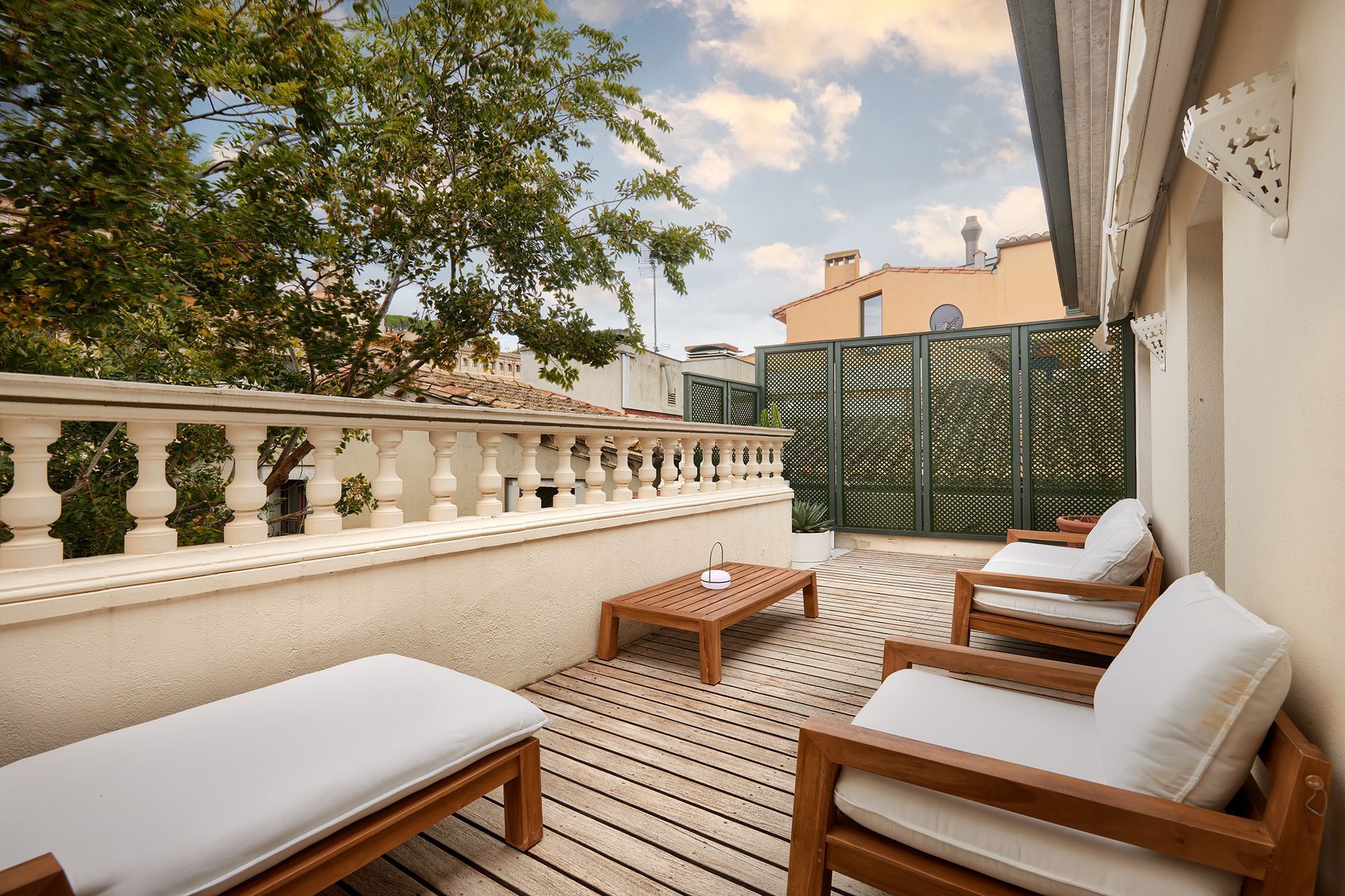 A balcony with chairs and a table on it