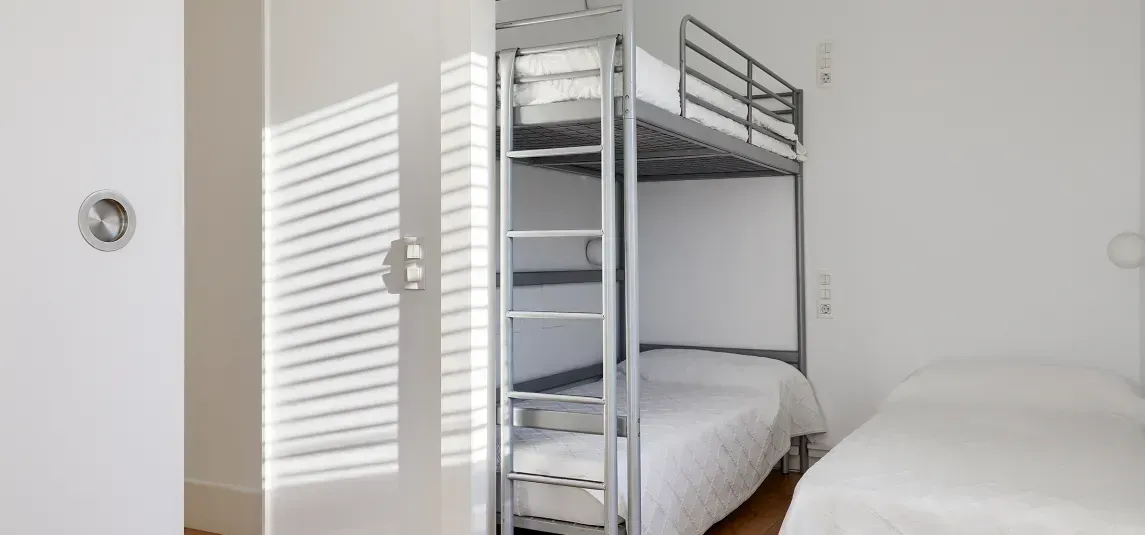 There is a bunk bed in the middle of the room.