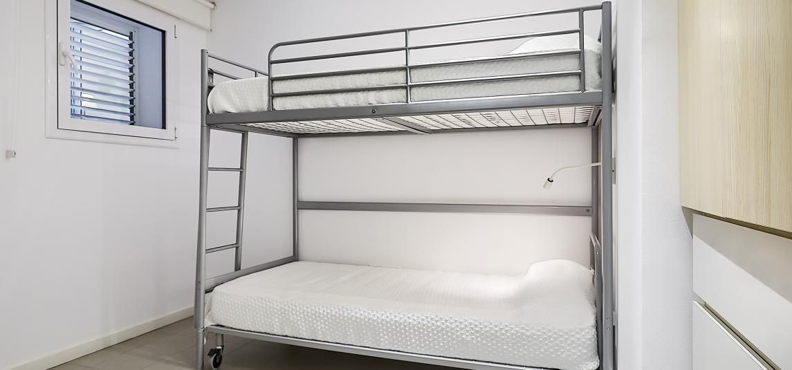 There is a bunk bed in the corner of the room.