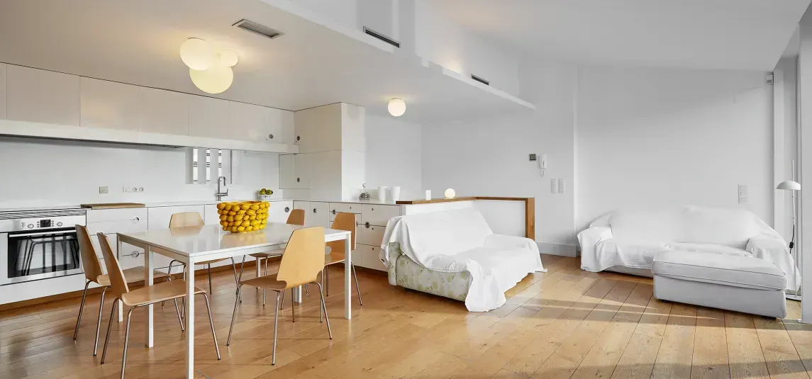 A living room with a dining table , chairs , and a couch.