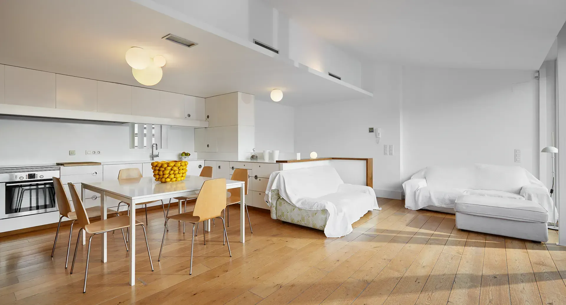 A living room with a table and chairs and a couch