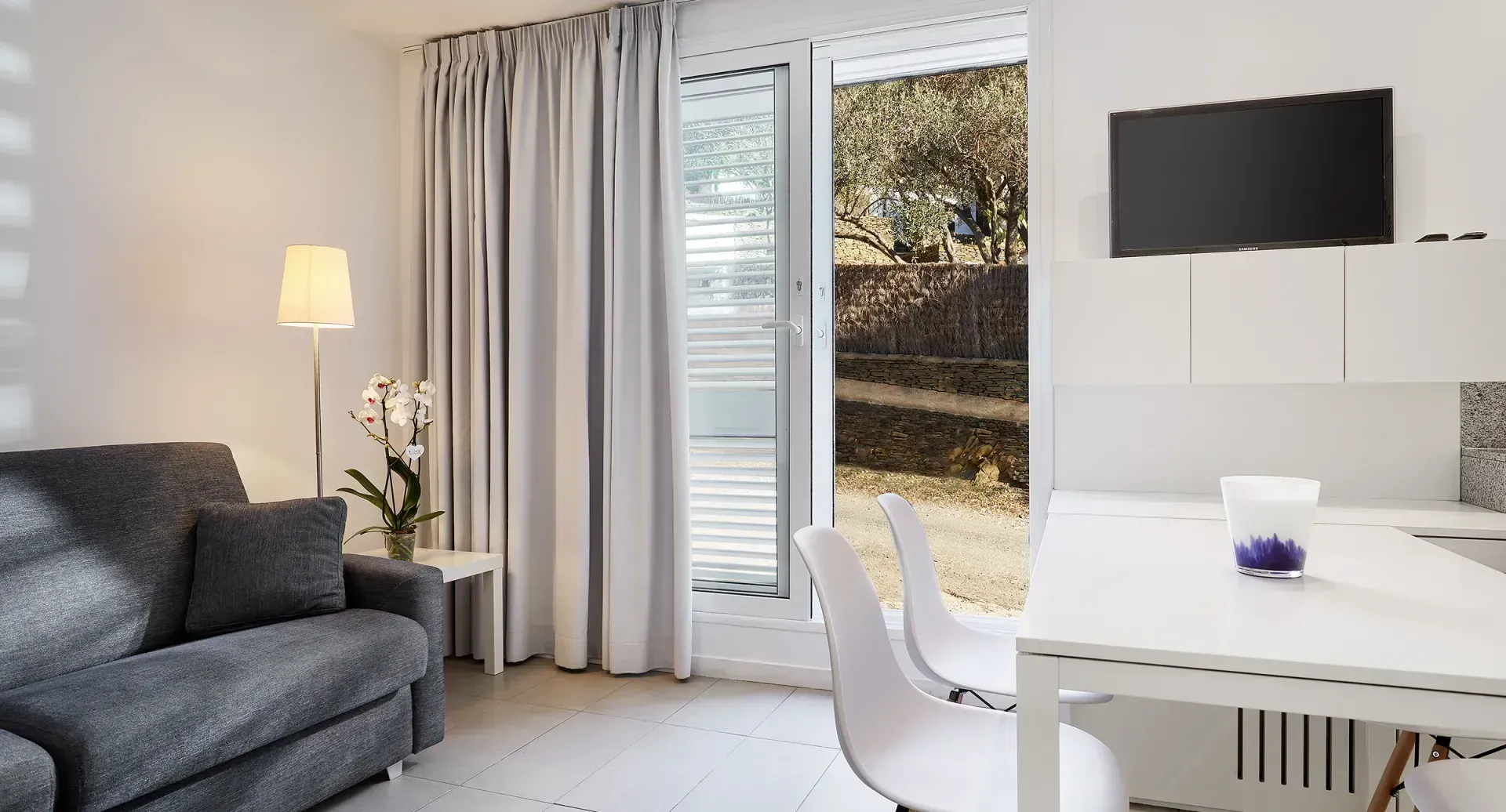 A living room with a couch , table and television