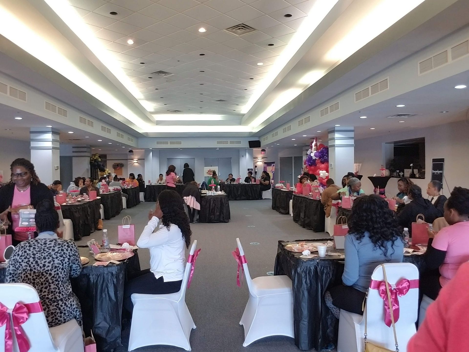 A group of people are sitting at tables in a large room