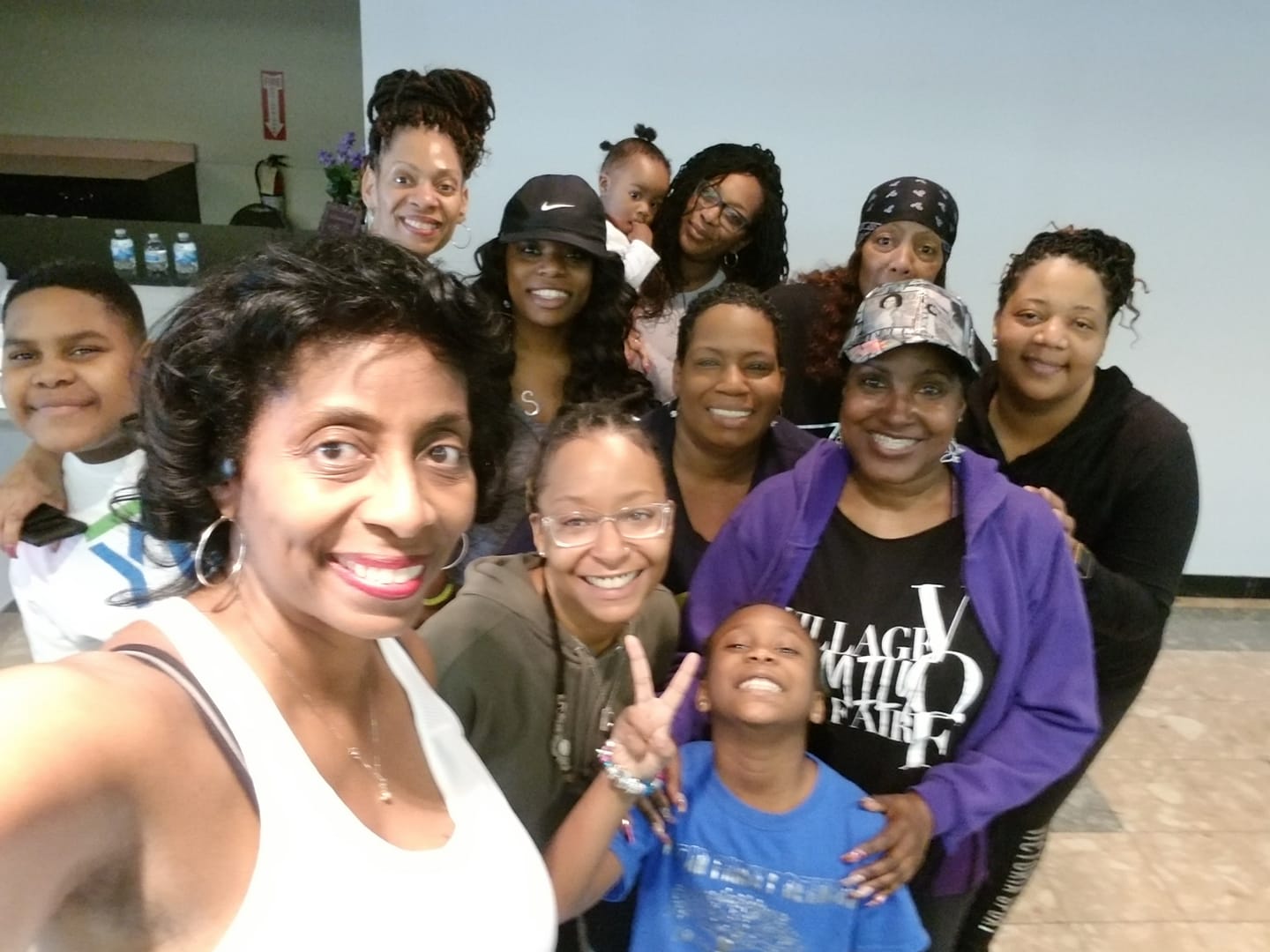 A group of people posing for a picture with one woman wearing a shirt that says 