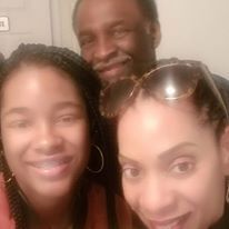 A man and two women are posing for a picture together.