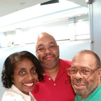 A group of three people are posing for a picture together.