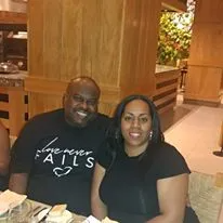 A man and a woman are sitting at a table in a restaurant.