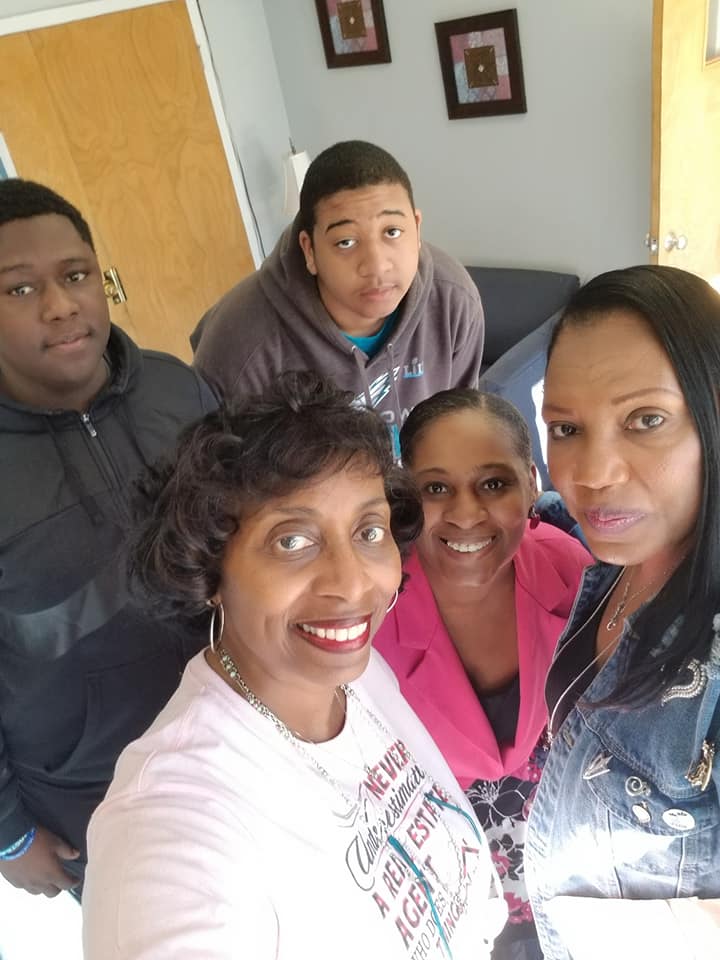 A group of people are posing for a picture and one of them is wearing a shirt that says ' always ' on it