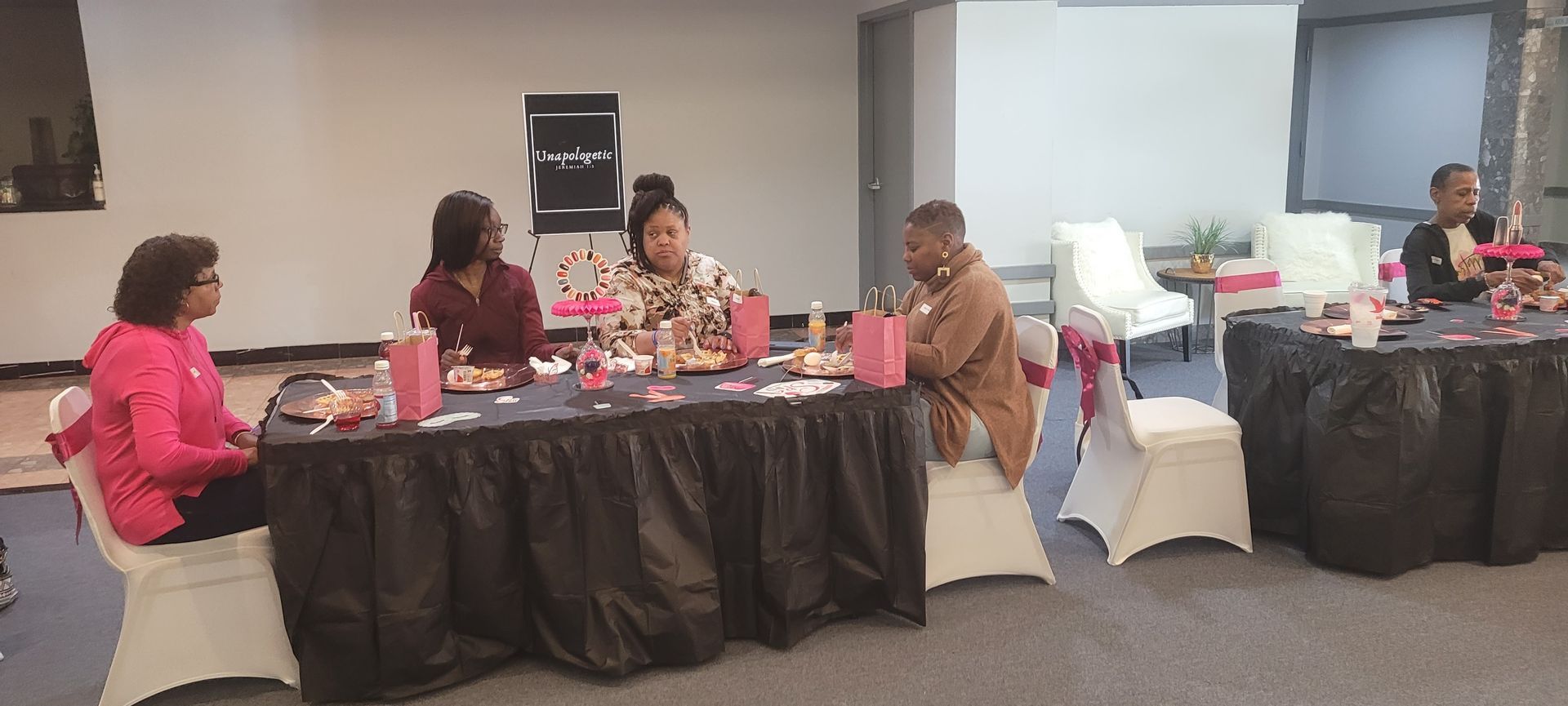 A group of people are sitting at tables in a room.