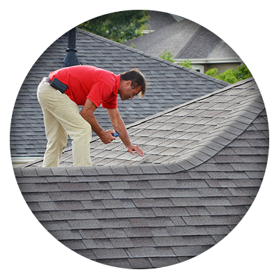man inspecting shingle roof