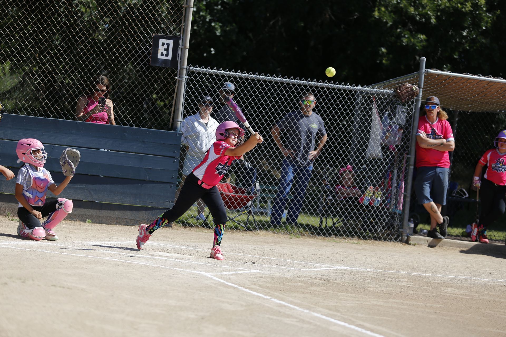 Softball player winding up to release a pitch