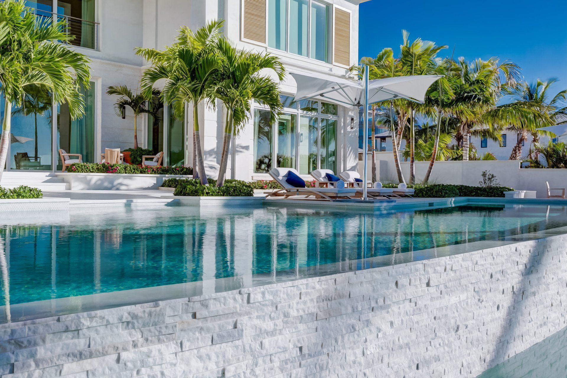 A large luxury white house with a swimming pool in the backyard shoot by Craig Westerman