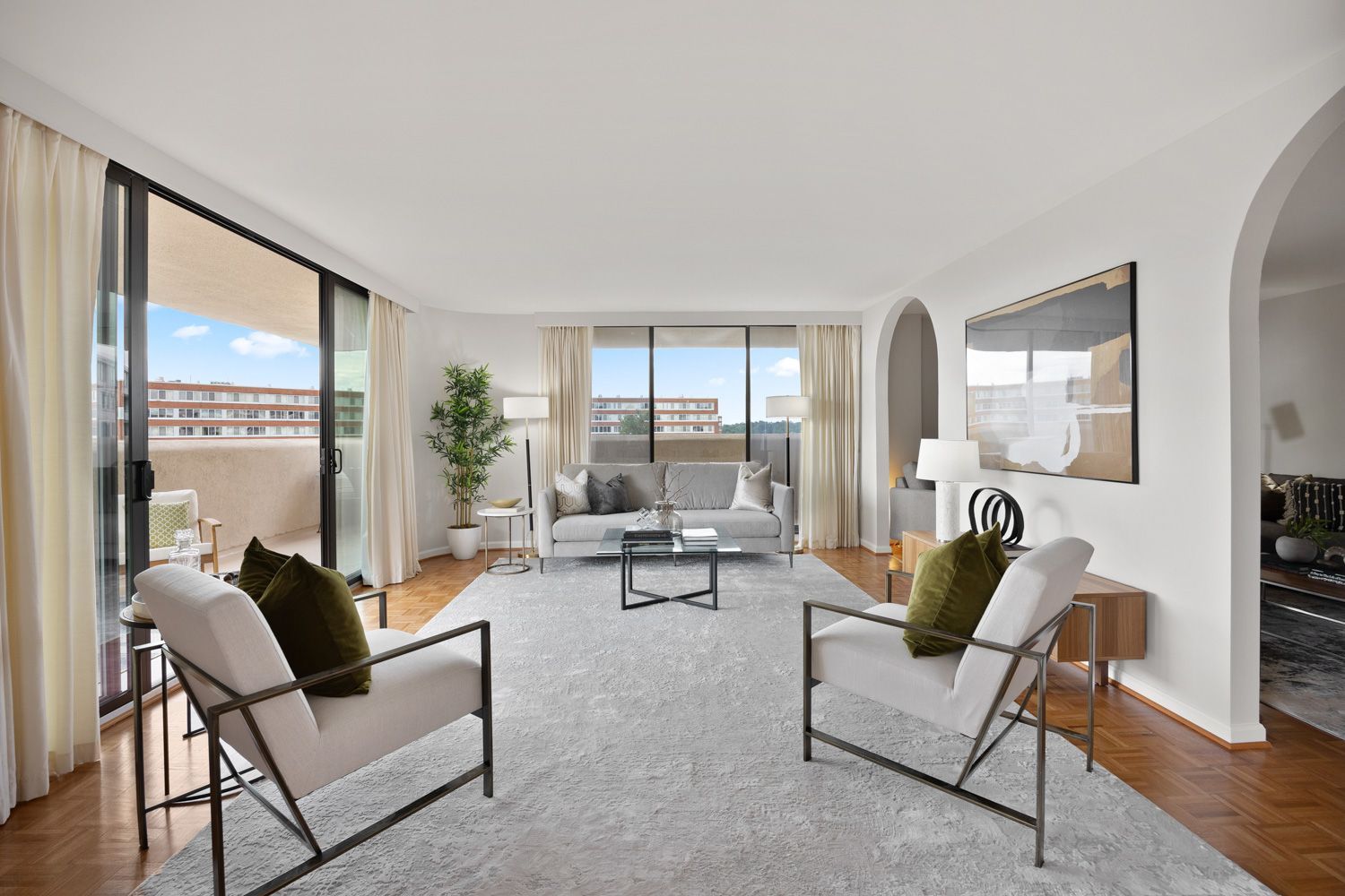 Living room with a couch, chairs, coffee table, and balcony in an Arlington, Virginia home, captured by Craig Westerman and the Hometrack Team, expert photographers near you.