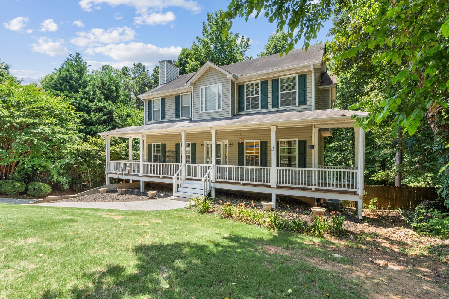 A large victorian house with a large porch and a large lawn in front of it in atlanta, georgia shoot by Craig Westerman and Hometrack team.