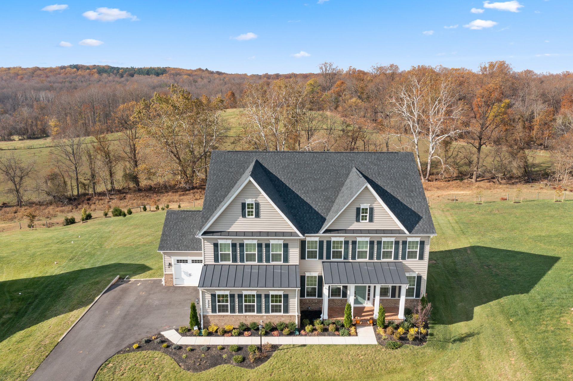 An aerial view of a house in a field with trees in the background in Clarksville, Maryland and shoot by Craig Westerman.