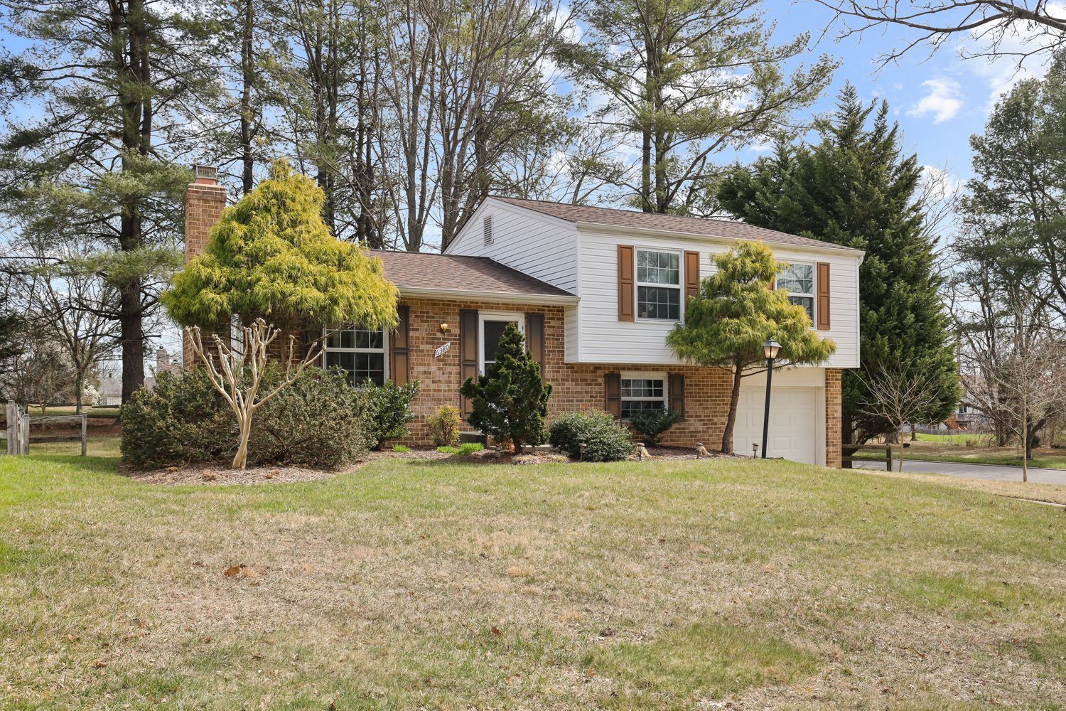 A house with a lot of grass and trees in front of it. Shoot by Hometrack