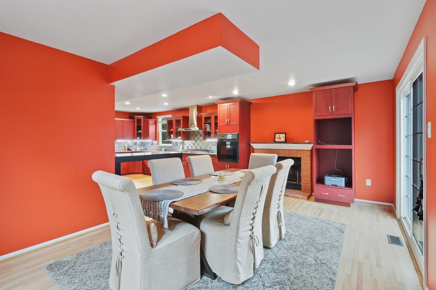 A Columbia, MD home and dining room with a table and chairs and orange walls. Shoot by Hometrack