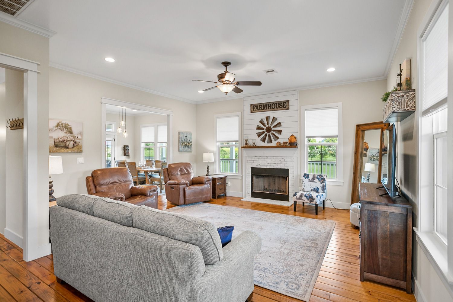 Houston home living room with a couch , chairs , fireplace and television shoot by Hometrack team. 