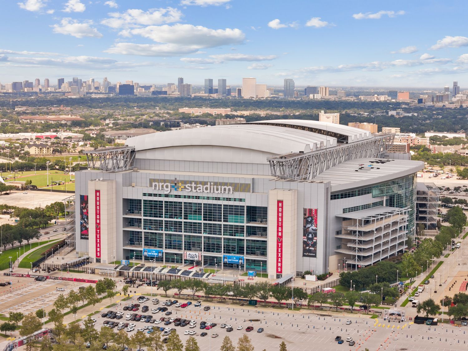 Aerial drone view capturing the iconic front of NRG Stadium in Houston, Texas, showcasing its grand architecture, captured by real estate photographers near you.