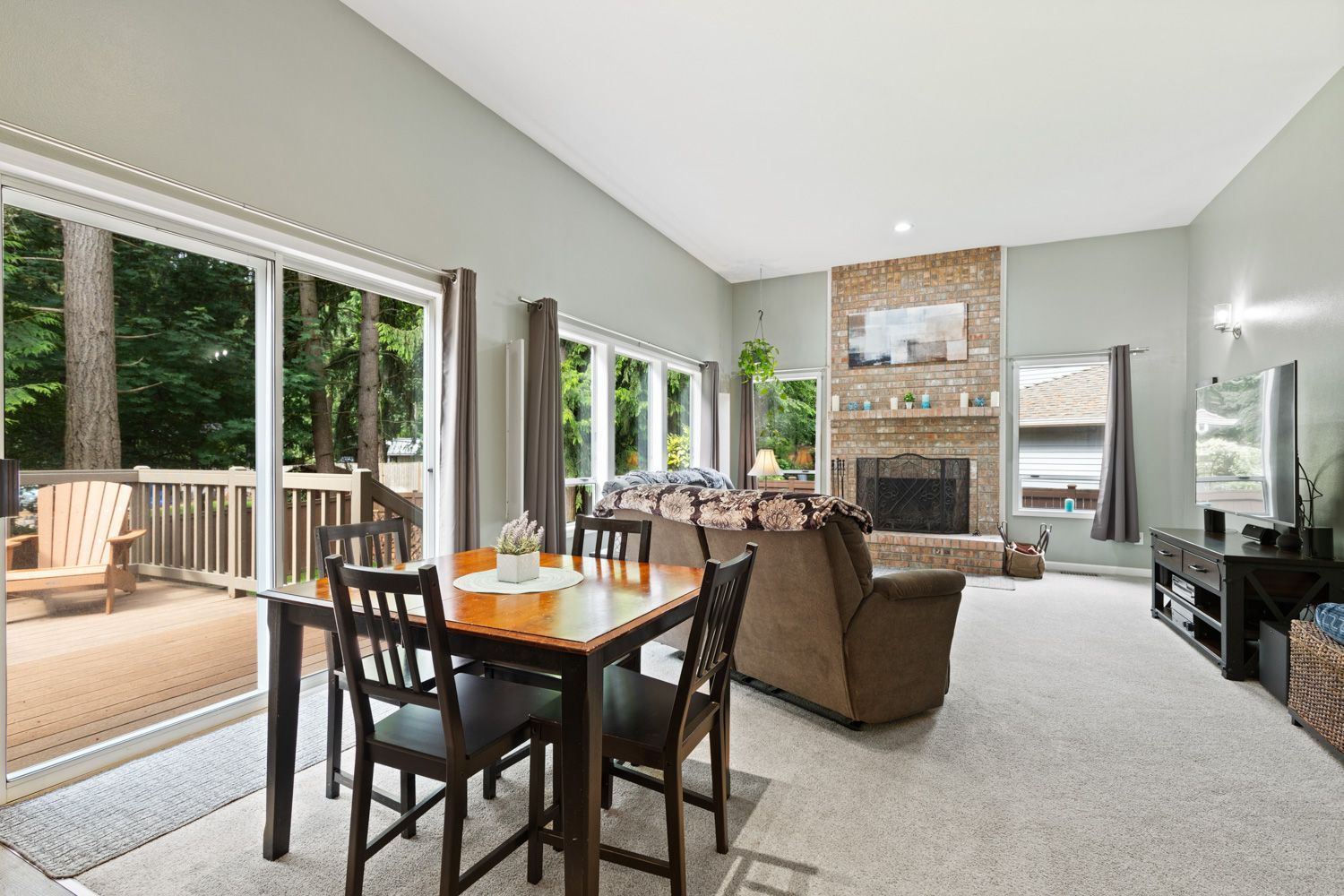 A living room with a dining table and chairs and a fireplace in Seattle Washington - photo shoot by Hometrack