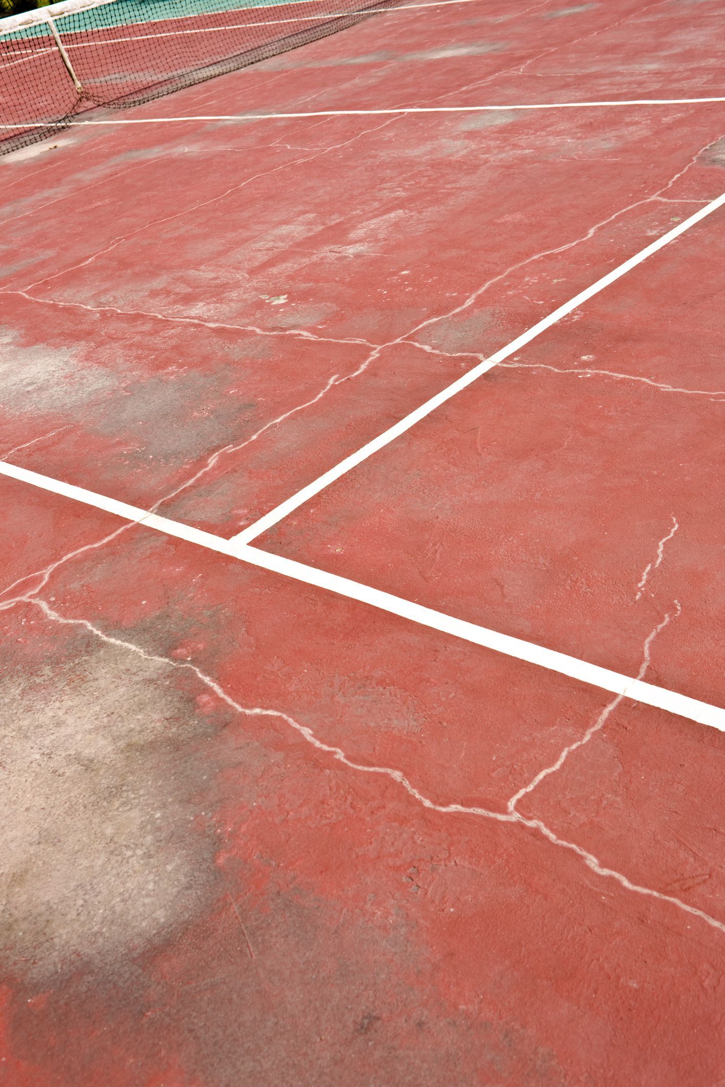 Asphalt with white square markings and black sealant, surface repair.