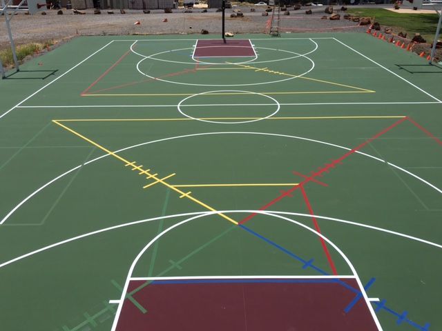 Basketball court with colorful lines overlaid for a geometric art project. Green and maroon color scheme.