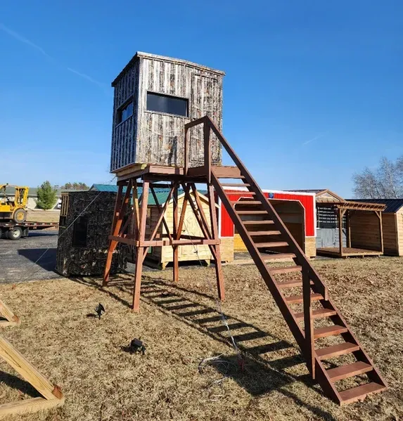 A wooden tower with stairs leading up to it