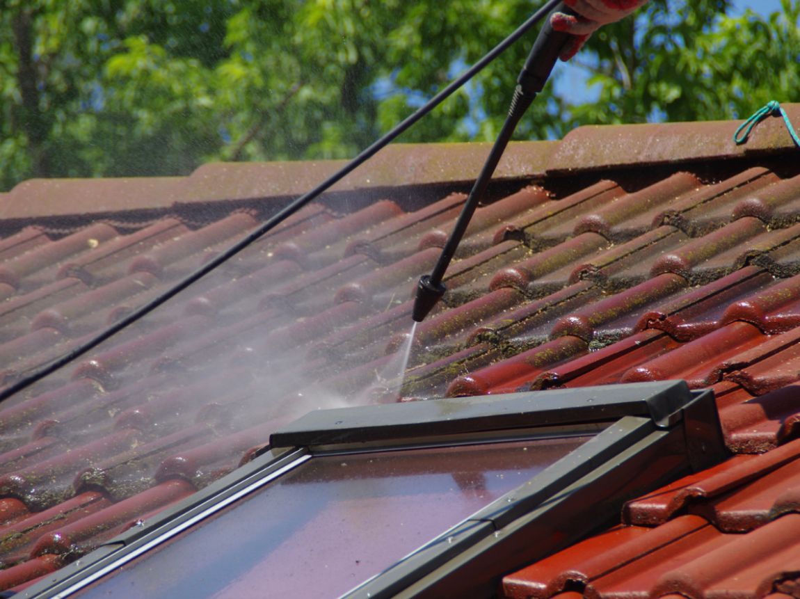 Ceramic shingles being pressure washed