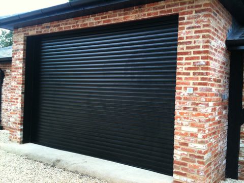 A newly fitted black roller garage door