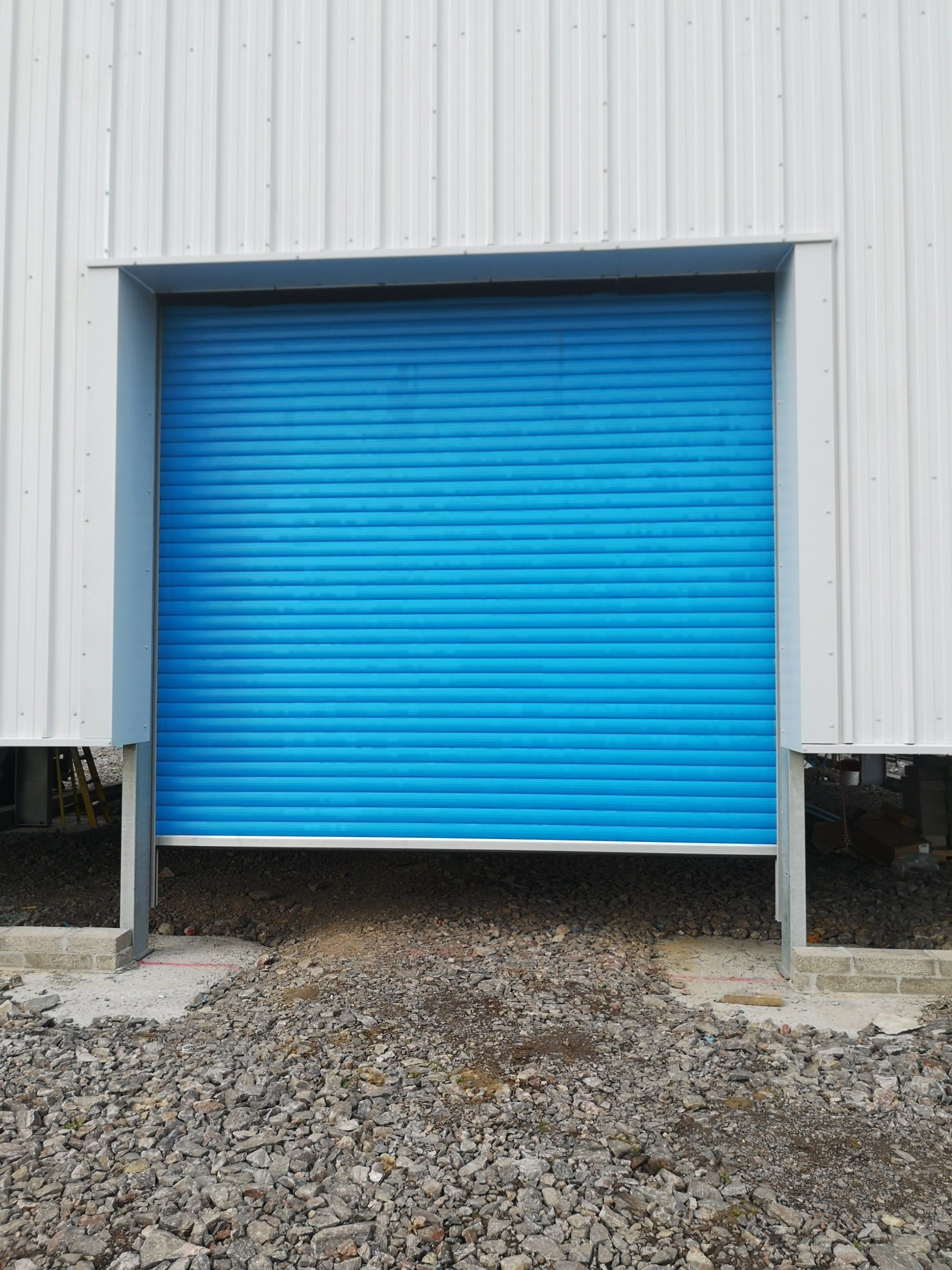 A recently fitted blue Industrial Roller garage door