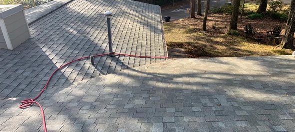 Pressure washing siding of house