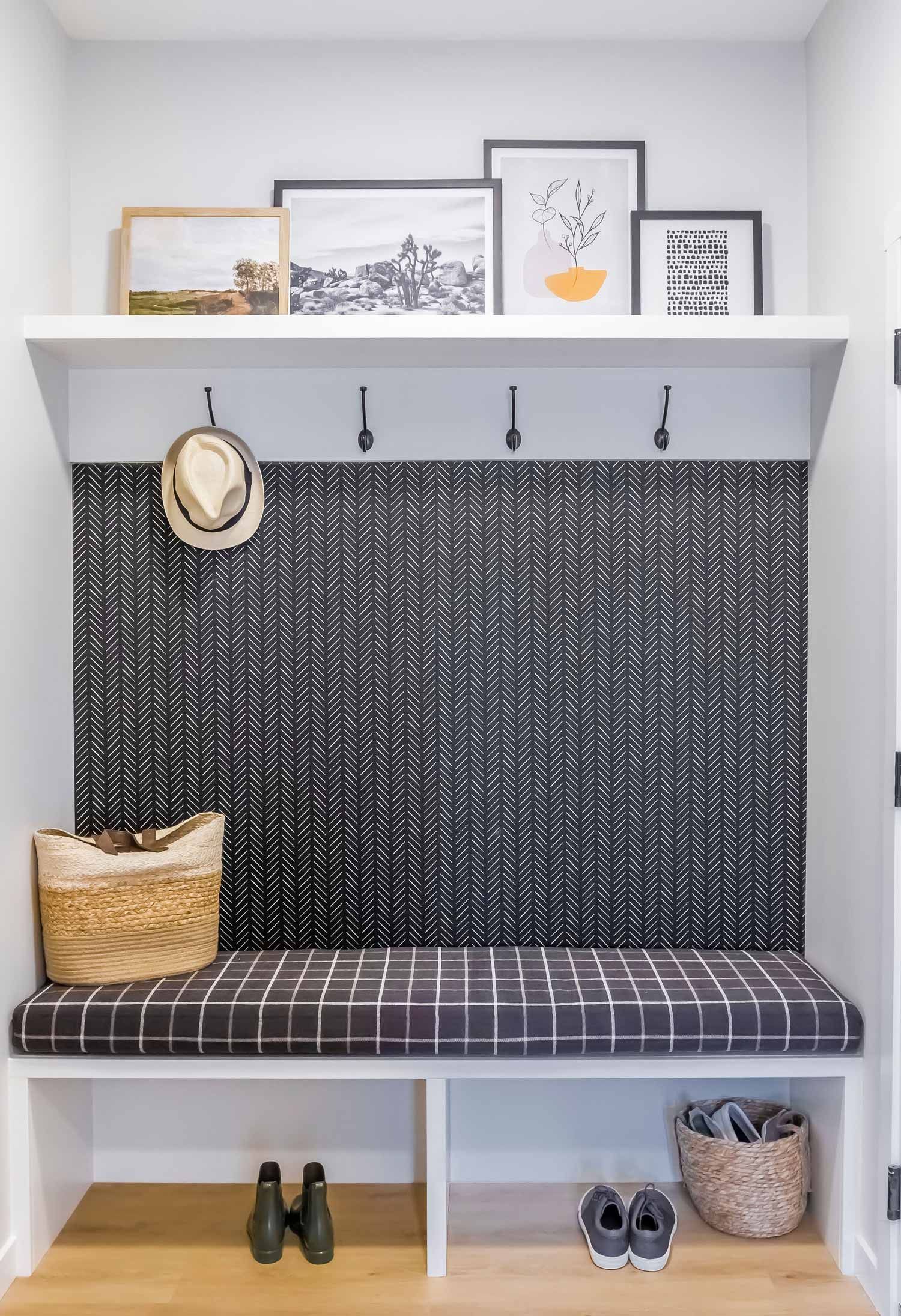 There is a bench in the middle of the room with a cushion on it.