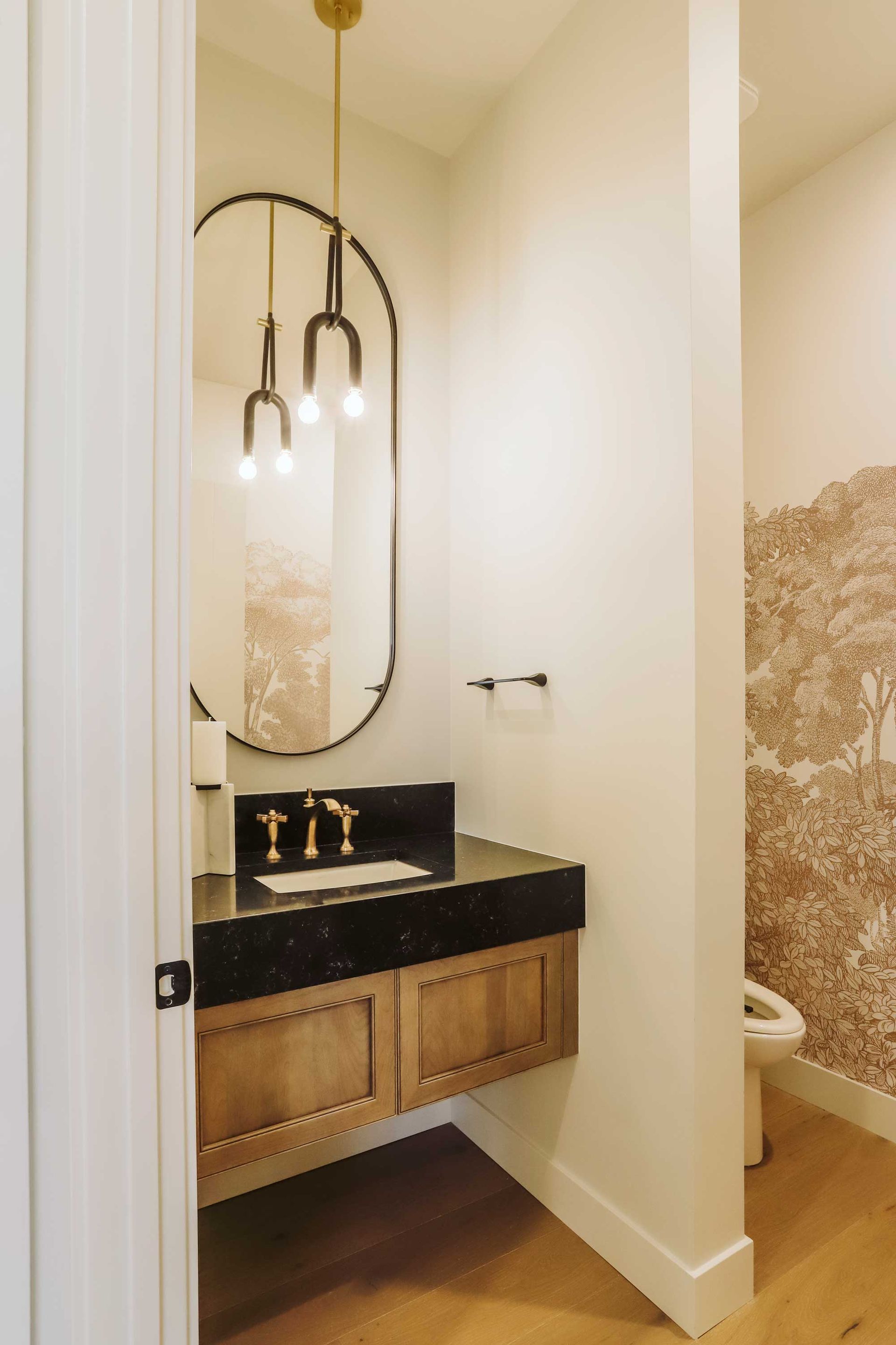 A bathroom with a sink , mirror and toilet.