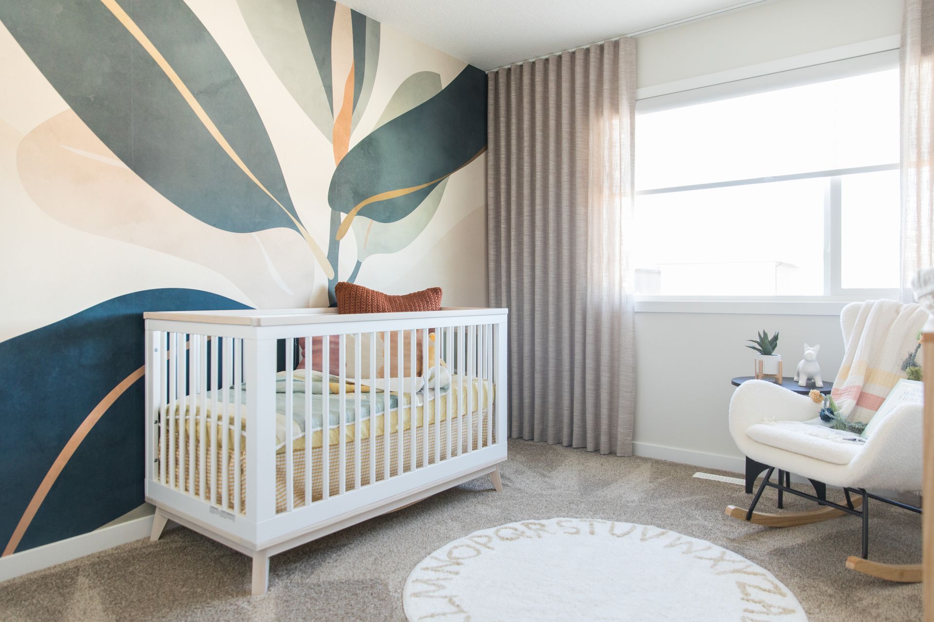 There is a crib and a rocking chair in the room.