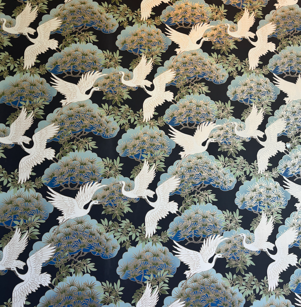 A pattern of birds and trees on a black background