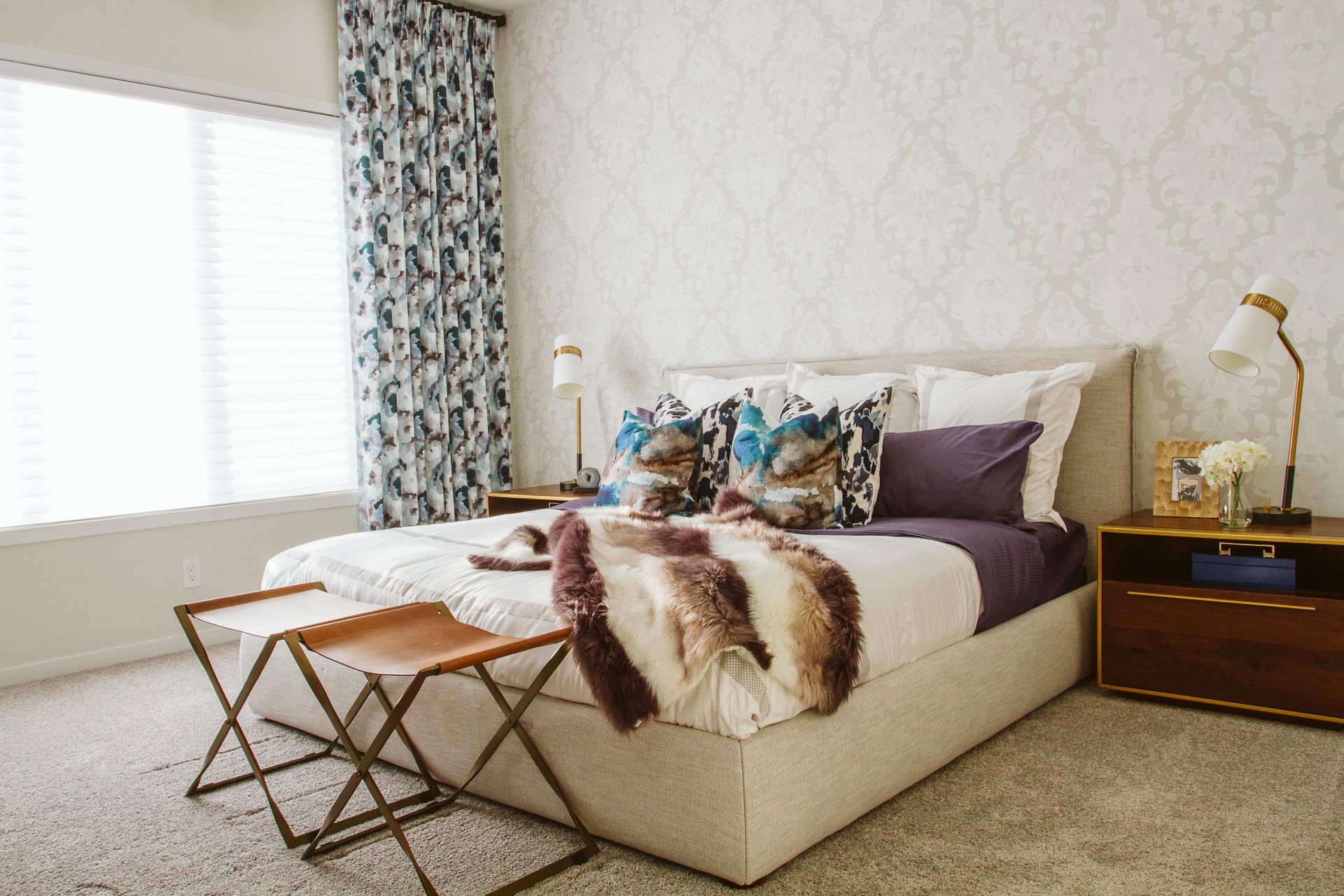 A bedroom with a bed , nightstand , and window.