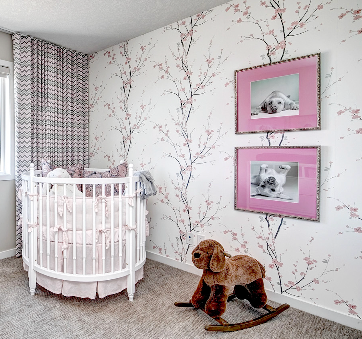 A baby 's room with a crib and a rocking horse