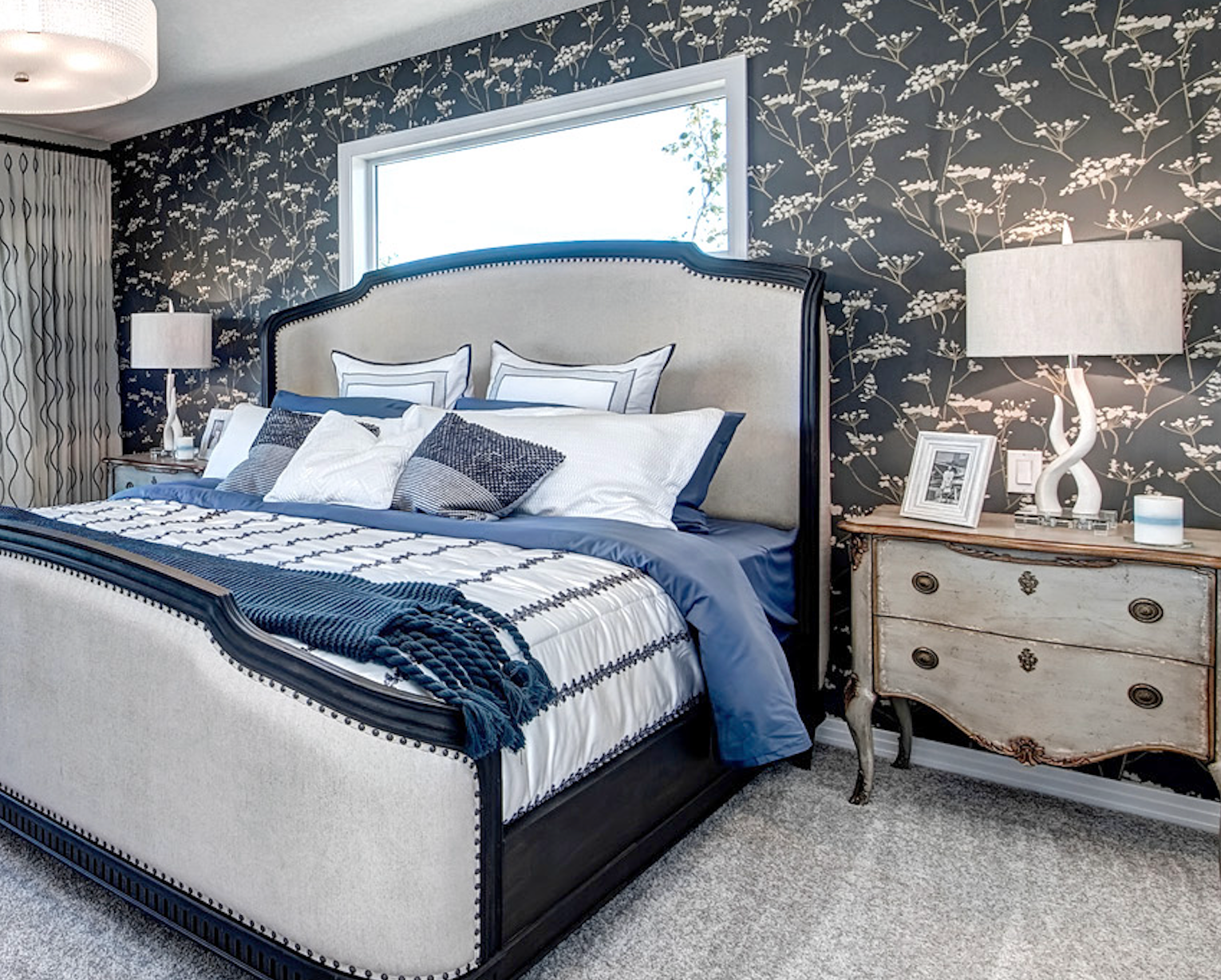 A bedroom with a large bed and a dresser